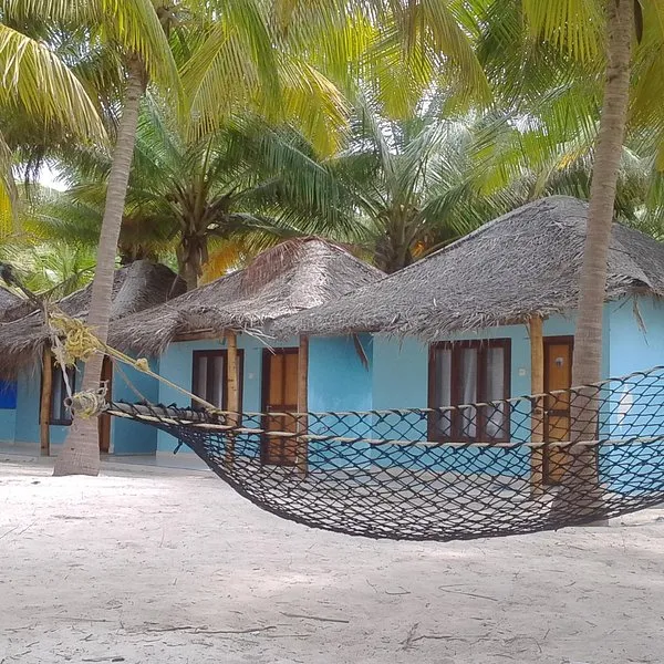 Sunny Goa beach with golden sand and blue ocean – popular beach holiday destination
